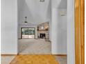 Spacious living room featuring a brick fireplace, sliding glass doors, and neutral carpeting at 715 Oak Ter, Orange City, FL 32763