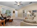 Cozy living room with vaulted ceilings, neutral color scheme, round rug, and comfortable seating area at 7462 Se 172Nd Fieldcrest St, The Villages, FL 32162