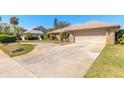 Circular driveway leading to a 2-car garage, surrounded by lush green lawn at 811 Smokerise Blvd, Port Orange, FL 32127