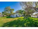 Single-story home with well-maintained lawn and mature trees at 912 Tree Garden Dr, Port Orange, FL 32127