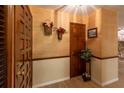 Elegant foyer with wood-look flooring, beautiful wallpaper, and warm lighting to welcome guests at 929 Torchwood Dr, Deland, FL 32724