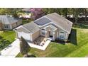 Inviting single-story home featuring a well-maintained lawn, a two-car garage and manicured landscaping at 1222 Brandy Lake View Cir, Winter Garden, FL 34787