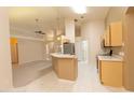 Open-concept kitchen features light-colored cabinetry and appliances, and tiled floors at 1222 Brandy Lake View Cir, Winter Garden, FL 34787