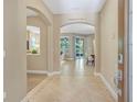 Elegant foyer with tile flooring, arched doorways, and a view into the living spaces at 1386 Hazeldene Mnr, Deland, FL 32724