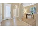 Welcoming entryway with tile flooring leading to a carpeted office space with ample natural light at 1386 Hazeldene Mnr, Deland, FL 32724