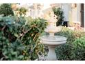 Stone fountain in a lush garden setting, adding tranquility to the landscape at 1606 Tango St, The Villages, FL 32163