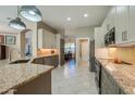 Modern kitchen featuring granite countertops, stainless steel appliances, and ample cabinet space at 1792 Arash Cir, Port Orange, FL 32128