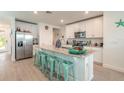 Bright kitchen featuring white cabinets, granite countertops, stainless steel appliances, and a center island at 207 Pitching Wedge Dr, Daytona Beach, FL 32124
