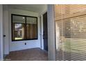 View of the front porch with tile floor, glass window and black front door at 210 Sage Brush Trl, Ormond Beach, FL 32174