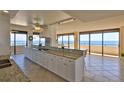 This open kitchen features a bar counter, granite countertops, and panoramic ocean views at 2200 N Atlantic Ave # 1201, Daytona Beach, FL 32118