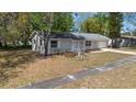 Aerial view of home featuring neutral exterior, landscaping, gray roof and driveway at 2240 Conway Dr, Deltona, FL 32738