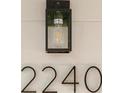 Close-up of the house number 2240 on the exterior of the home with light fixture at 2240 Conway Dr, Deltona, FL 32738