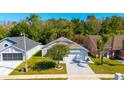 Aerial view showcases this well-maintained home, featuring a lush lawn and a driveway at 2274 Stonehedge Loop, Kissimmee, FL 34743