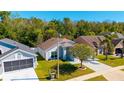 Aerial view of a well-maintained home featuring a landscaped yard and driveway at 2274 Stonehedge Loop, Kissimmee, FL 34743