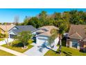 Aerial view of the property, featuring well-maintained landscaping and an attached two-car garage at 2274 Stonehedge Loop, Kissimmee, FL 34743