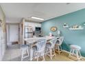 Bright kitchen featuring a breakfast bar with seating, modern appliances, and ample counter space at 2480 Ocean Shore Blvd # 120, Ormond Beach, FL 32176