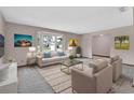 Bright living room featuring a large window, neutral tones, and stylish furniture at 3041 Millstone Ave, Deltona, FL 32738