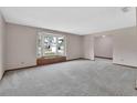 Spacious living room with large bay window and neutral carpet at 3041 Millstone Ave, Deltona, FL 32738