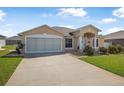 Attractive one-story home featuring well-kept yard, welcoming entrance, and a convenient two-car garage at 307 Mariners Gate Dr, Edgewater, FL 32141