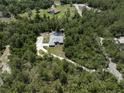 Private home with pool nestled among mature trees on a large lot, providing seclusion at 3211 Hidden Crest Ln, Deland, FL 32724