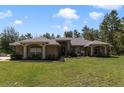 Well-maintained home with lush front yard and brick exterior, featuring large windows at 3211 Hidden Crest Ln, Deland, FL 32724