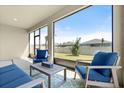 Comfortable screened patio with outdoor seating, perfect for relaxation and enjoying the backyard view at 322 E Merimont Ln, Ormond Beach, FL 32174
