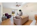 Bright living room with vaulted ceilings, a ceiling fan, and sliding glass doors leading to backyard at 3237 Cranston St, Deltona, FL 32738