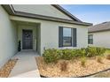 Charming home featuring a stylish entry and a well manicured landscape at 3845 Arborvitae Way, Deland, FL 32724