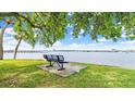Bench seating with a scenic view of the waterfront property, showcasing a tranquil outdoor experience at 411 N Halifax Ave # 304, Daytona Beach, FL 32118