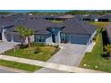 Attractive single-Gathering home featuring a paved driveway, well-kept lawn, and appealing landscaping, enhancing its overall charm at 418 Aquamarine Way, Daytona Beach, FL 32124