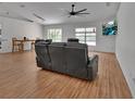 Spacious living room with wood floors, large windows, and contemporary furnishings at 4600 S Tomoka Dr, De Leon Springs, FL 32130