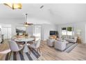 Bright living room with light hardwood floors, neutral tones and comfortable seating at 484 Sherwood Oaks Rd, Orange City, FL 32763