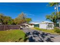 Fenced backyard with garage and outbuilding in the rear at 501 Powers Ave, Port Orange, FL 32127