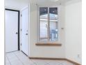 Bright entryway featuring neutral walls, tile flooring, and a front door with adjacent window at 509 Lake Bridge Dr, Ormond Beach, FL 32174