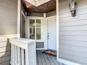 Inviting front entryway with a solid white door, porch, and a decorative light fixture at 509 Lake Bridge Dr, Ormond Beach, FL 32174