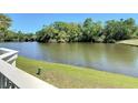Scenic view overlooking a tranquil pond surrounded by lush greenery, creating a serene outdoor space at 509 Lake Bridge Dr, Ormond Beach, FL 32174