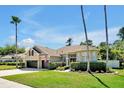 Beautiful one-story home featuring manicured landscaping and a two-car garage at 5808 Oak Lake Trl, Oviedo, FL 32765