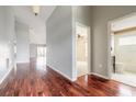 Spacious hallway with gleaming wood floors leading to various rooms in the home at 6794 Calistoga Cir, Port Orange, FL 32128
