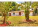 Charming single-story home featuring a well-manicured lawn, double front doors, and an attached one-car garage at 816 Overhill Rd, Deland, FL 32720