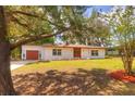 Charming single-story home featuring a well-manicured lawn, double front doors, and an attached one-car garage at 816 Overhill Rd, Deland, FL 32720