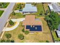 Aerial view of a home with solar panels on the roof and a circular driveway in a residential neighborhood at 863 Riverside Dr, Ormond Beach, FL 32176