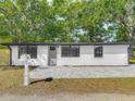 The front exterior of a cozy single-story home features a paved front patio and a well-maintained mailbox at 102 Judges Ln, Port Orange, FL 32129