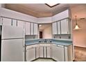 Functional kitchen featuring ample cabinet space, stainless steel sink, and white appliances at 1167 Peachtree Rd, Daytona Beach, FL 32114