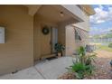 Inviting front door with a wreath and landscaping at 120 Hibiscus Woods Ct # 2A, Deltona, FL 32725