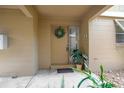 Charming front door with a wreath and decorative potted plants at 120 Hibiscus Woods Ct # 2A, Deltona, FL 32725