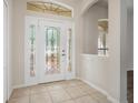 Elegant foyer features a decorative glass front door and neutral tile flooring at 1253 Bramley Ln, Deland, FL 32720