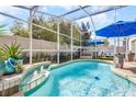 Inviting screened-in pool area with lounge chairs and a soothing water feature for relaxation at 13944 Huntwick Dr, Orlando, FL 32837