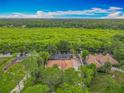 Beautiful aerial view of a single-Gathering home with a screened pool, lush landscaping, and amazing waterfront views at 1578 Stone Trl, Deltona, FL 32725