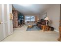 Comfortable living room with a brick fireplace, large TV, and cozy seating area at 219 Lynnhurst Dr, Ormond Beach, FL 32176
