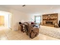 Bright living room with tile floors, brick fireplace, comfortable seating and doorway to bathroom at 2309 6Th Ave, Deland, FL 32724